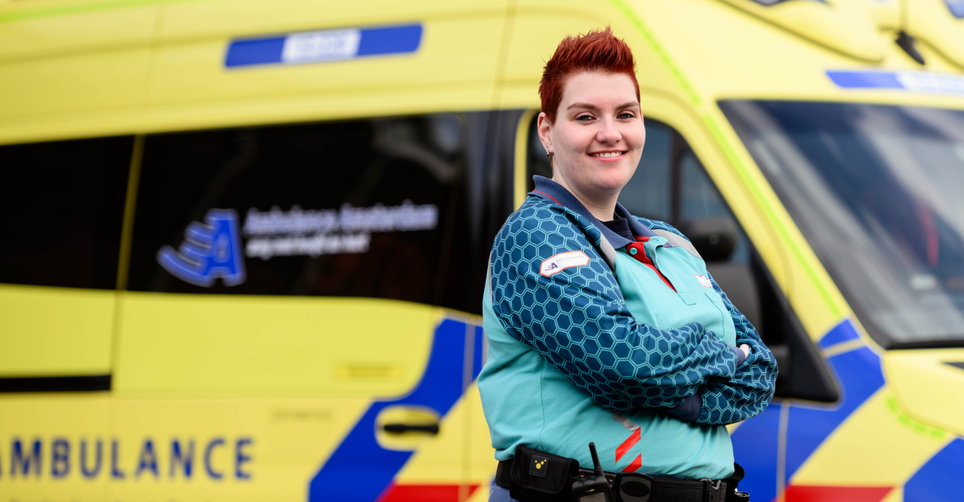 Verpleegkundige poseert voor ambulance